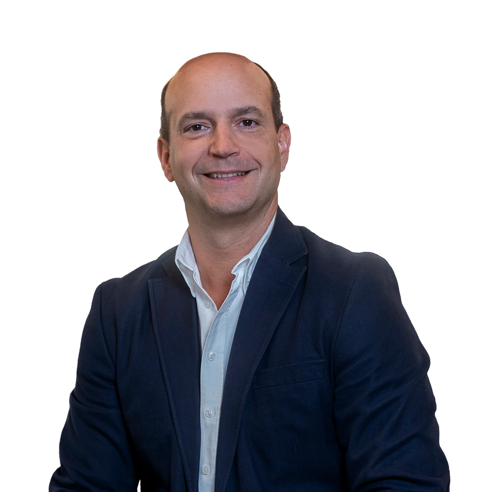 Portrait of Manuel Lavin wearing a dark blazer and a light-colored shirt, smiling confidently.