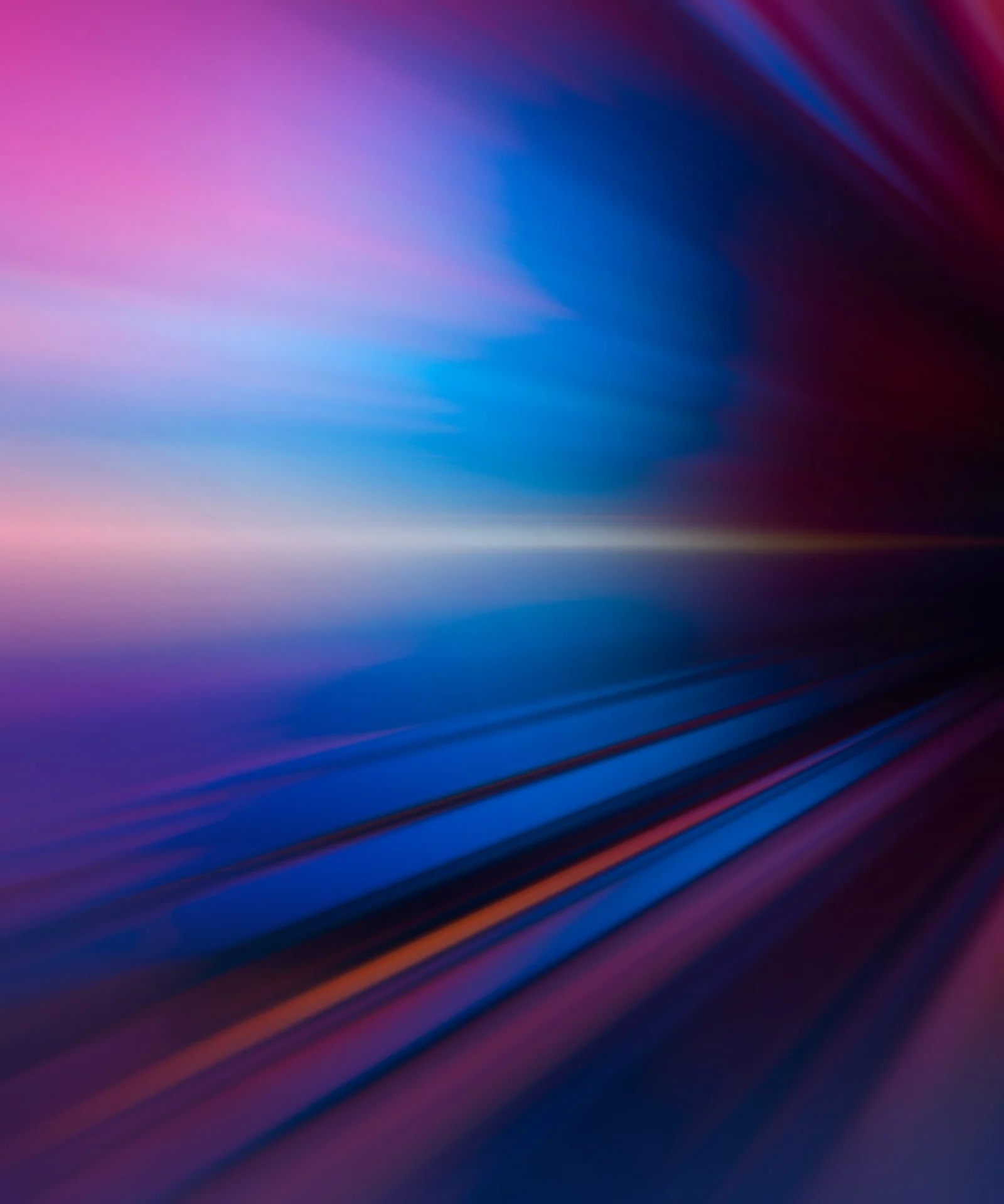 An abstract, vibrant image with streaks of blue, pink, and orange, symbolizing the dynamic impact of AI and technology on the digital landscape.