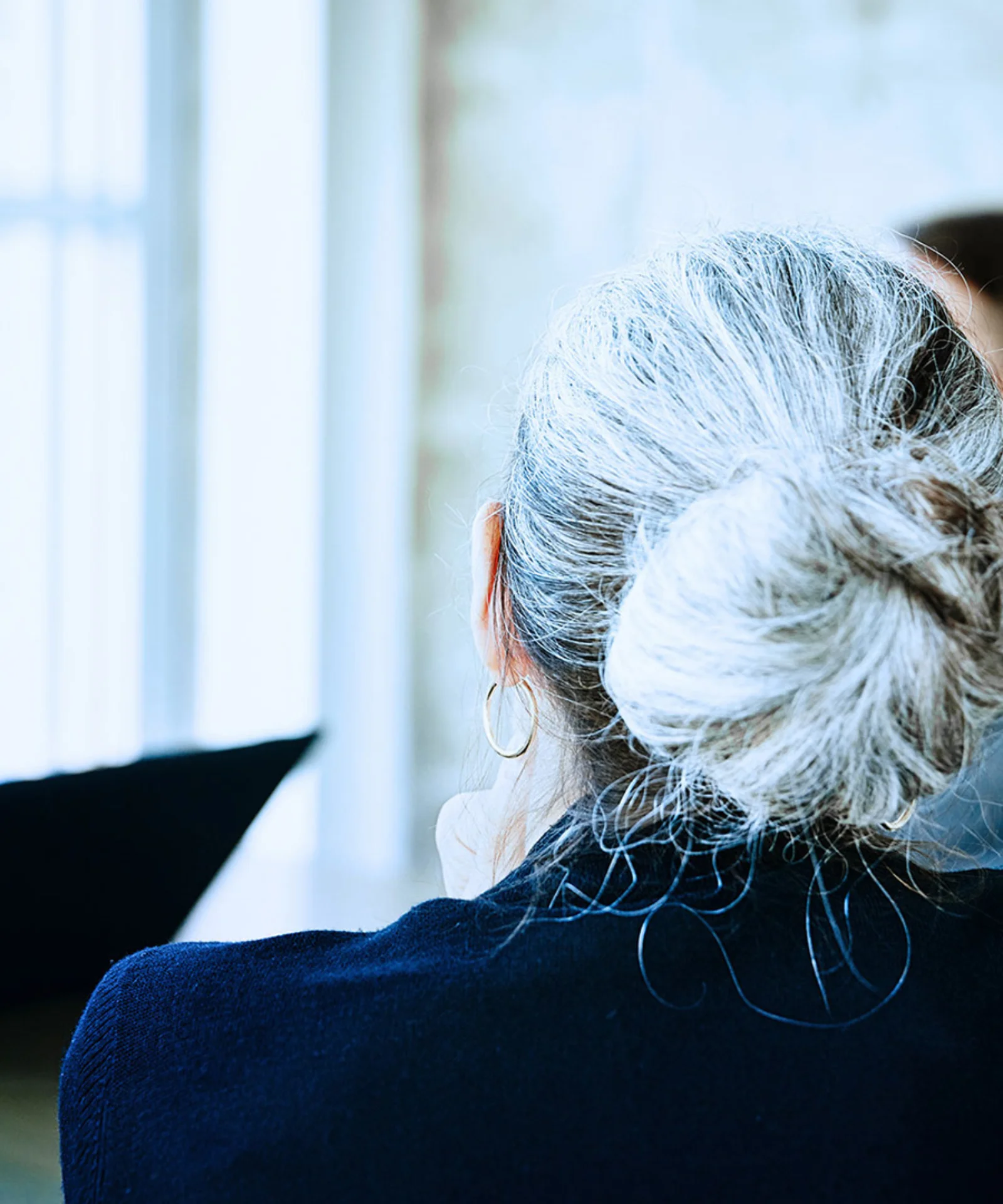 Key visual for investor relations showing a diverse business meeting with a focus on a woman with grey hair in a bun.