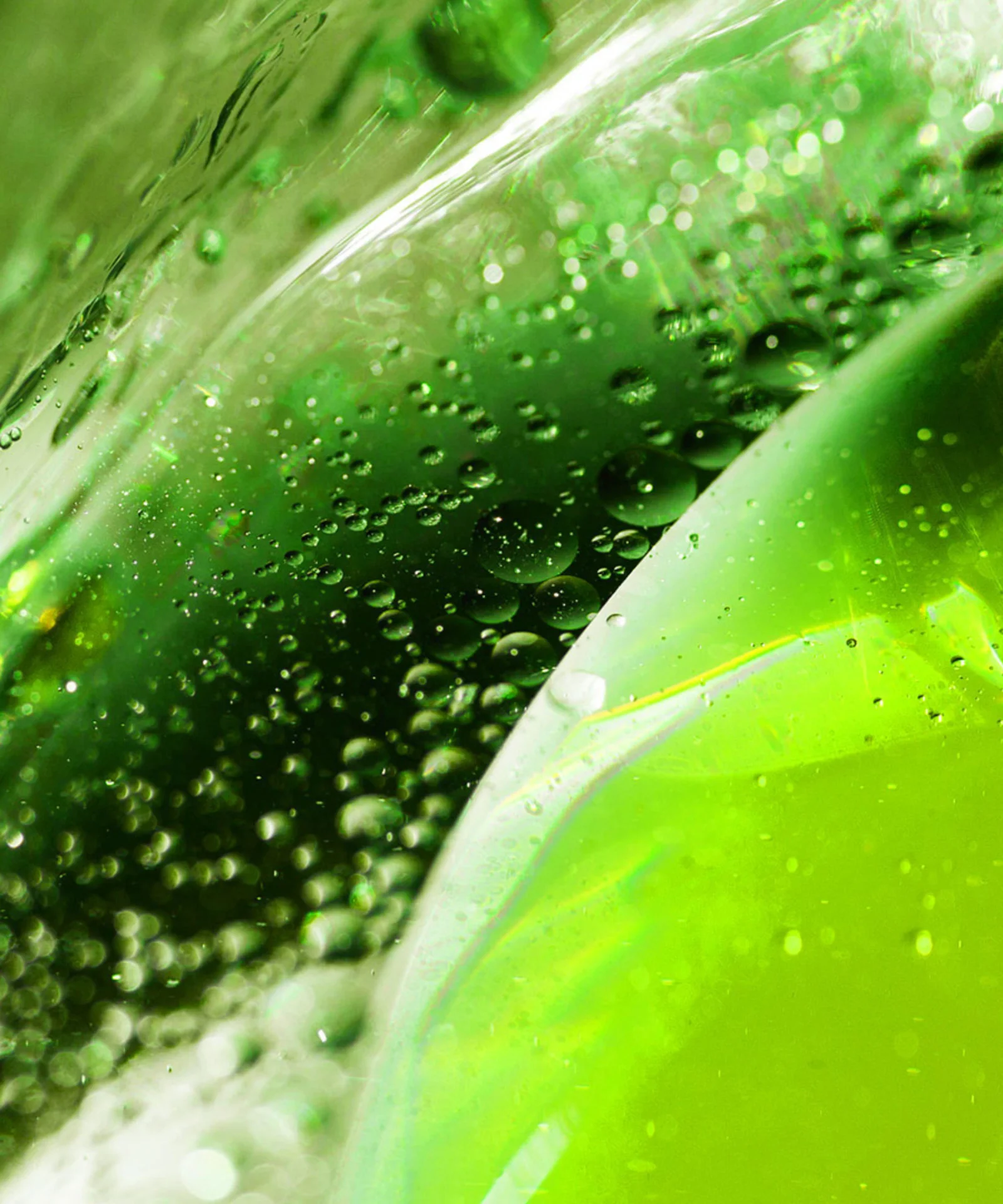 Macro shot of vibrant green liquid with bubbles, symbolizing sustainability and eco-friendly investments.