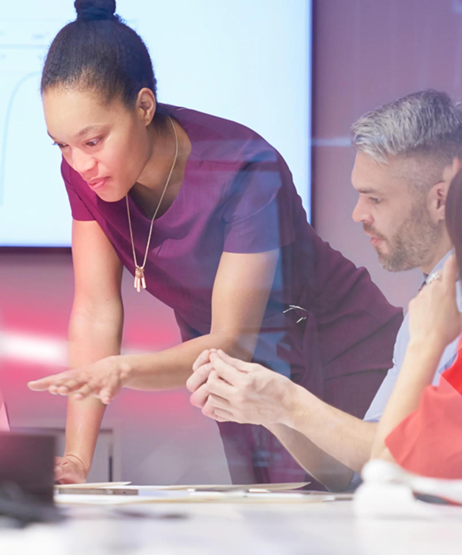 A group of professionals collaborating during a strategic meeting, with a focus on core banking transformation and digital agility. The image features dynamic lighting effects and a modern office setting.