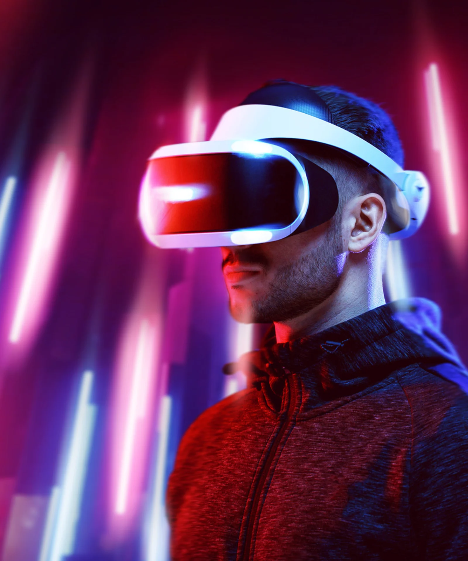 A person wearing a VR headset, illuminated by vibrant, colourful lights, representing the cutting-edge of immersive technology.