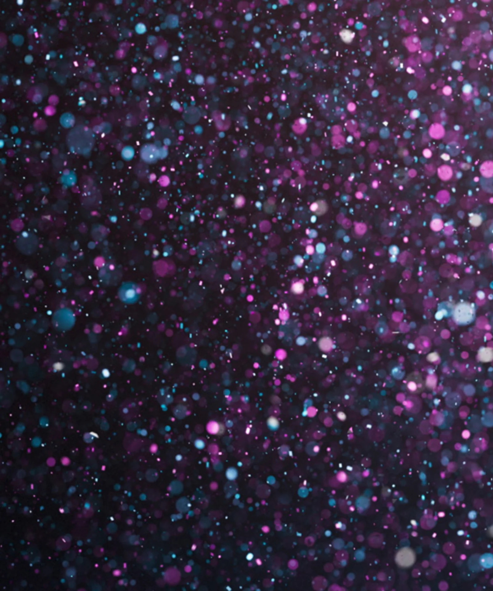 Abstract image with a left-aligned focus, featuring a glittering background of purple, blue, and white sparkles. The design symbolises GFT&#039;s numerous awards and achievements.