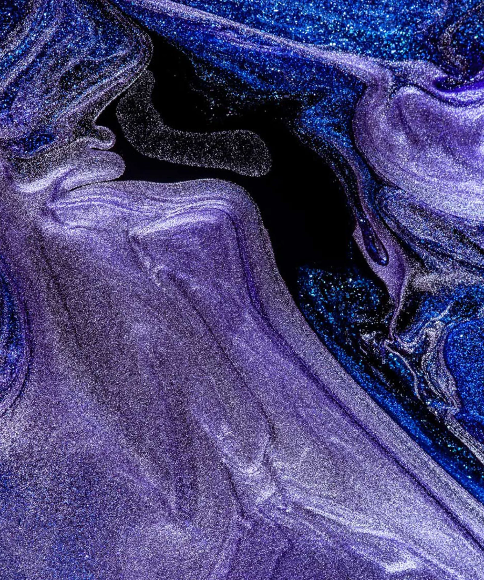 An abstract visual featuring swirling patterns of blue and purple colors, representing creativity and innovation in design services.