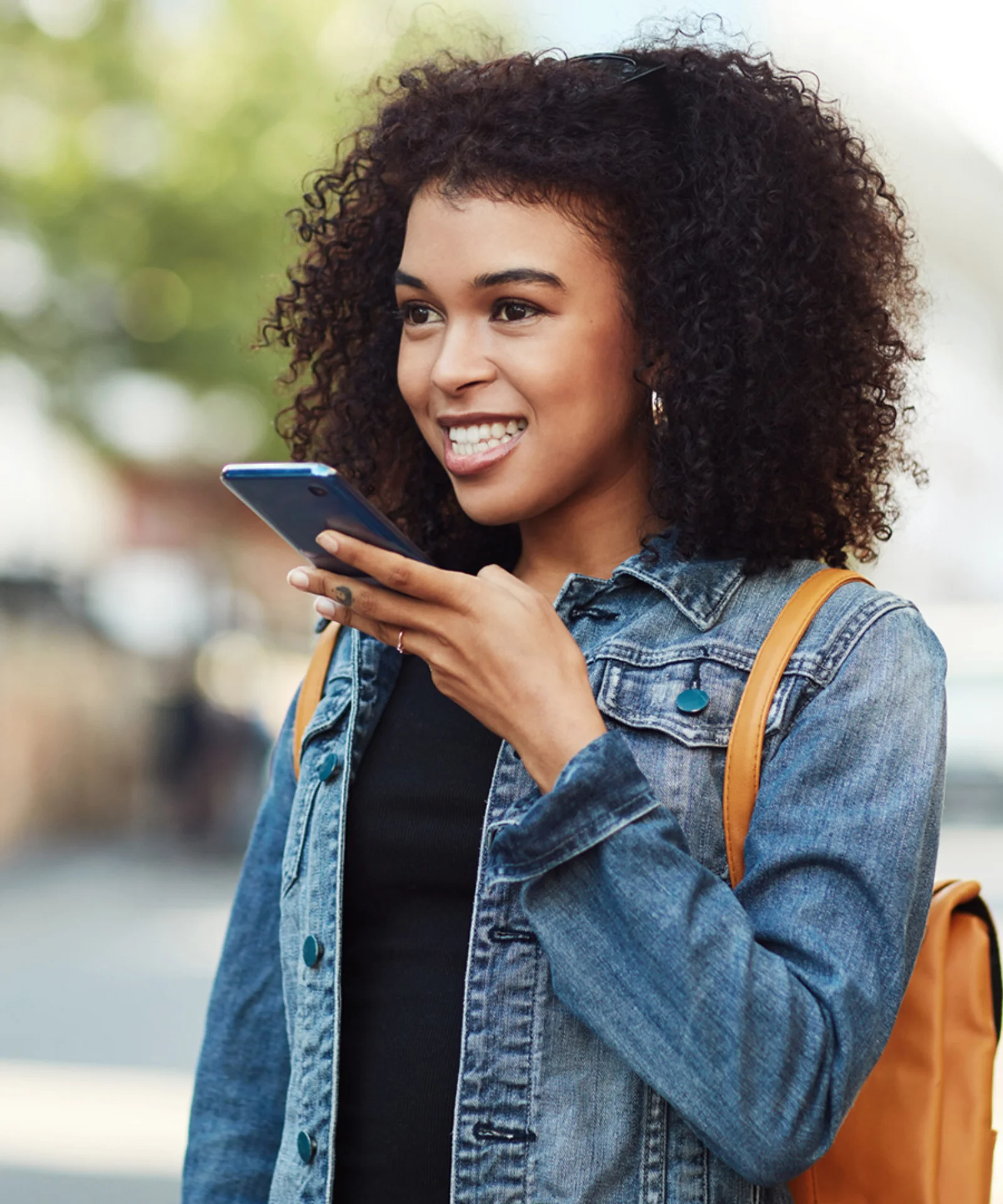 A young woman using voice commands on her smartphone, representing enhanced customer service through Google Assistant integration.