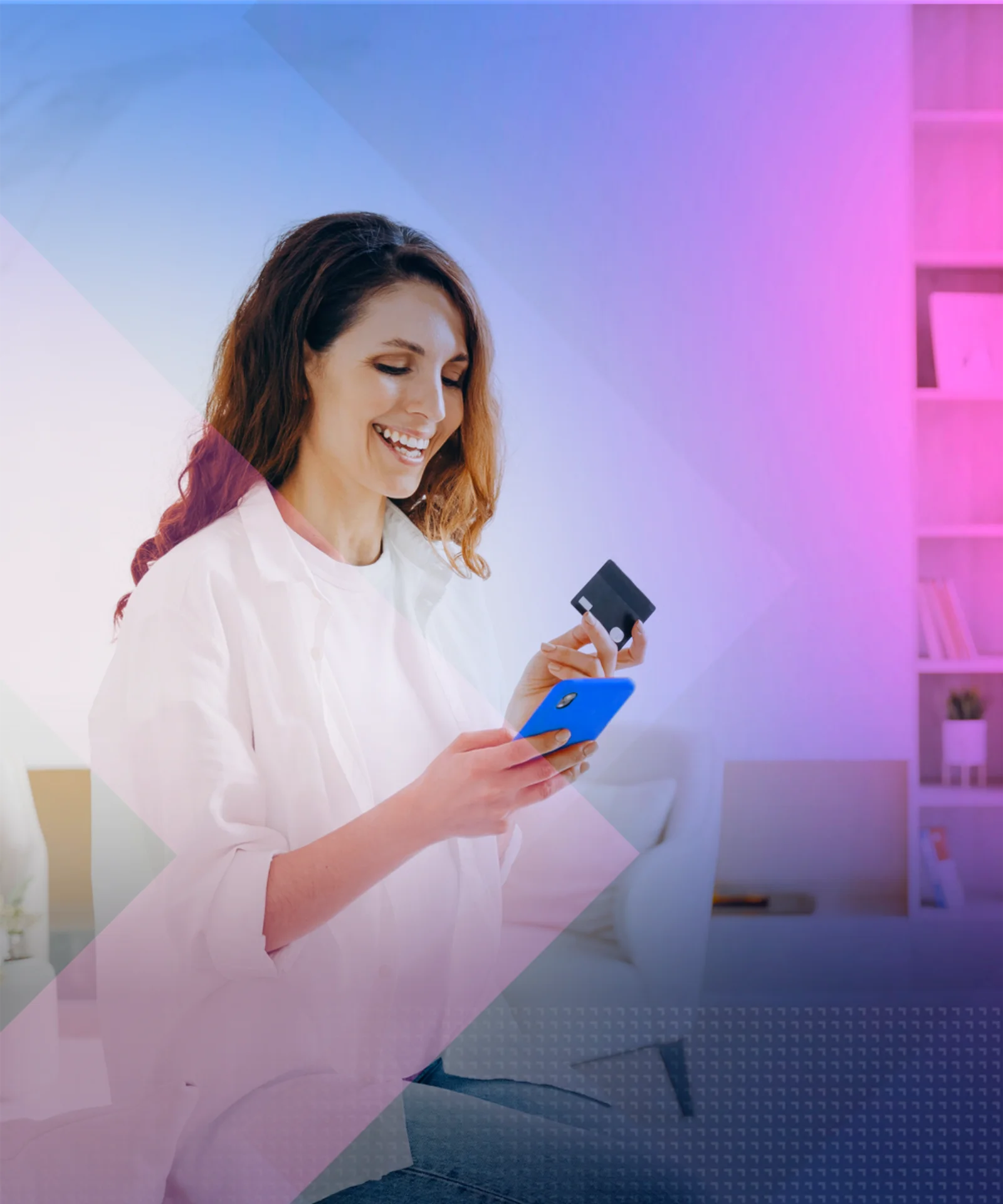 Woman smiling while using a smartphone to make an online payment, holding a credit card in her hand.