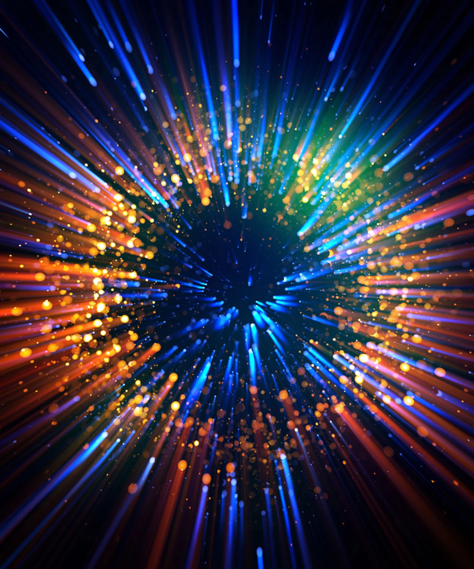 Abstract explosion of colourful light rays and particles against a dark background.