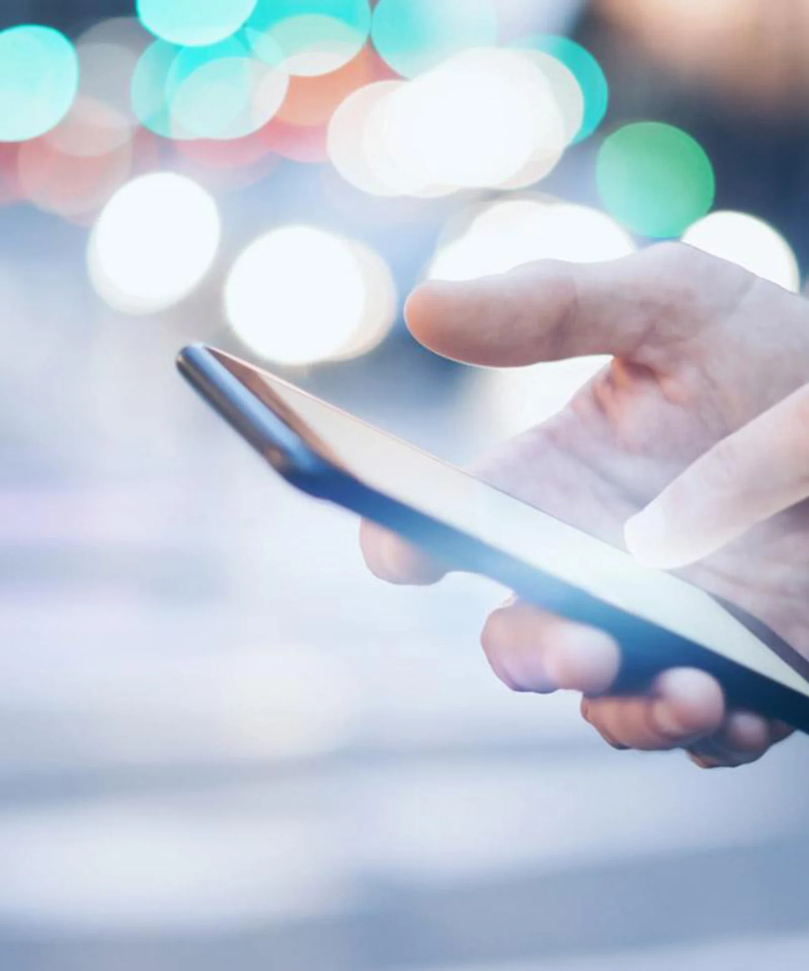 Close-up of a person using a smartphone, symbolising the integration of open banking technology by Bank Leumi.