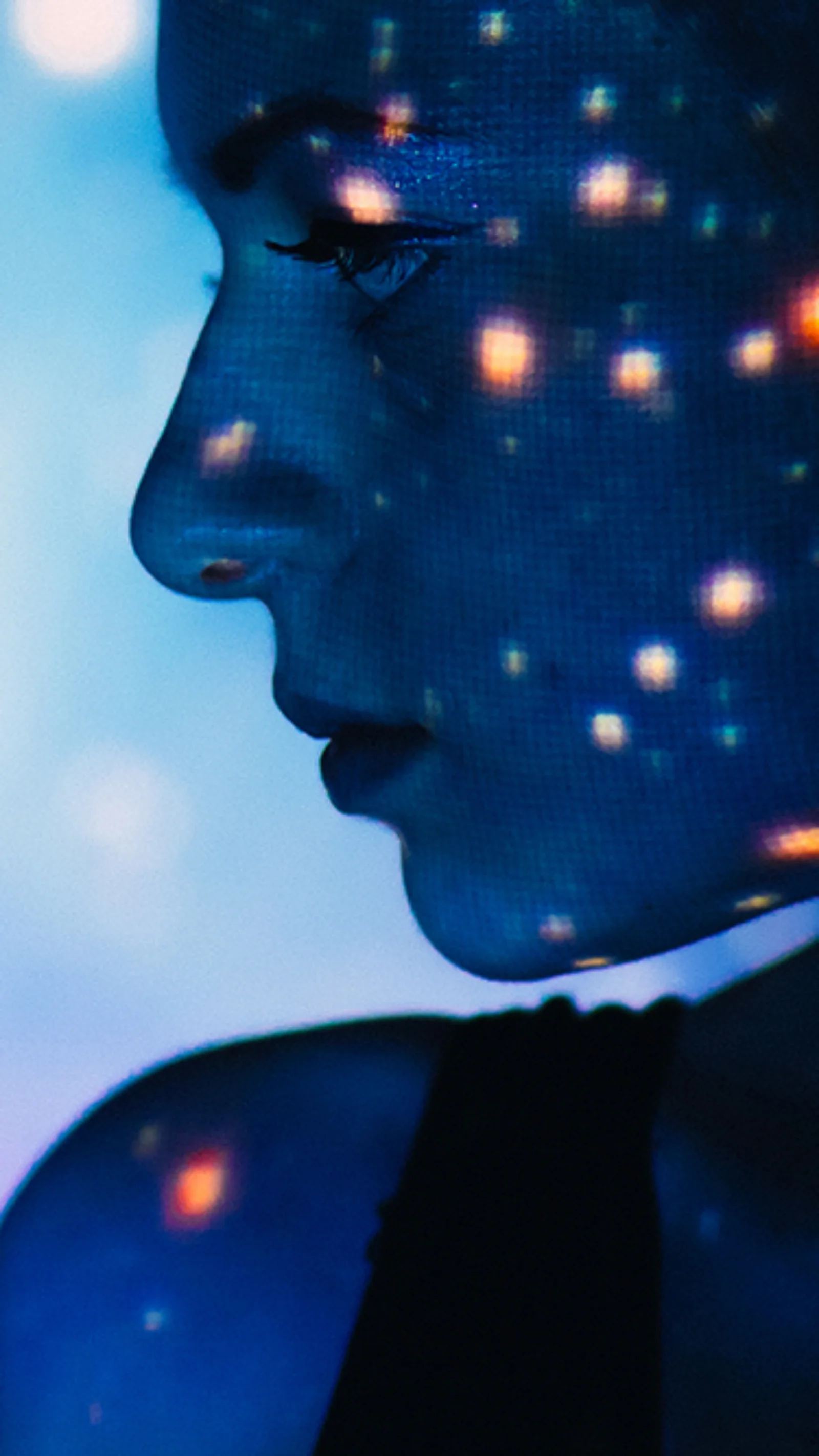 Silhouette of a woman with digital lights projected on her face, set against a vibrant, futuristic background.