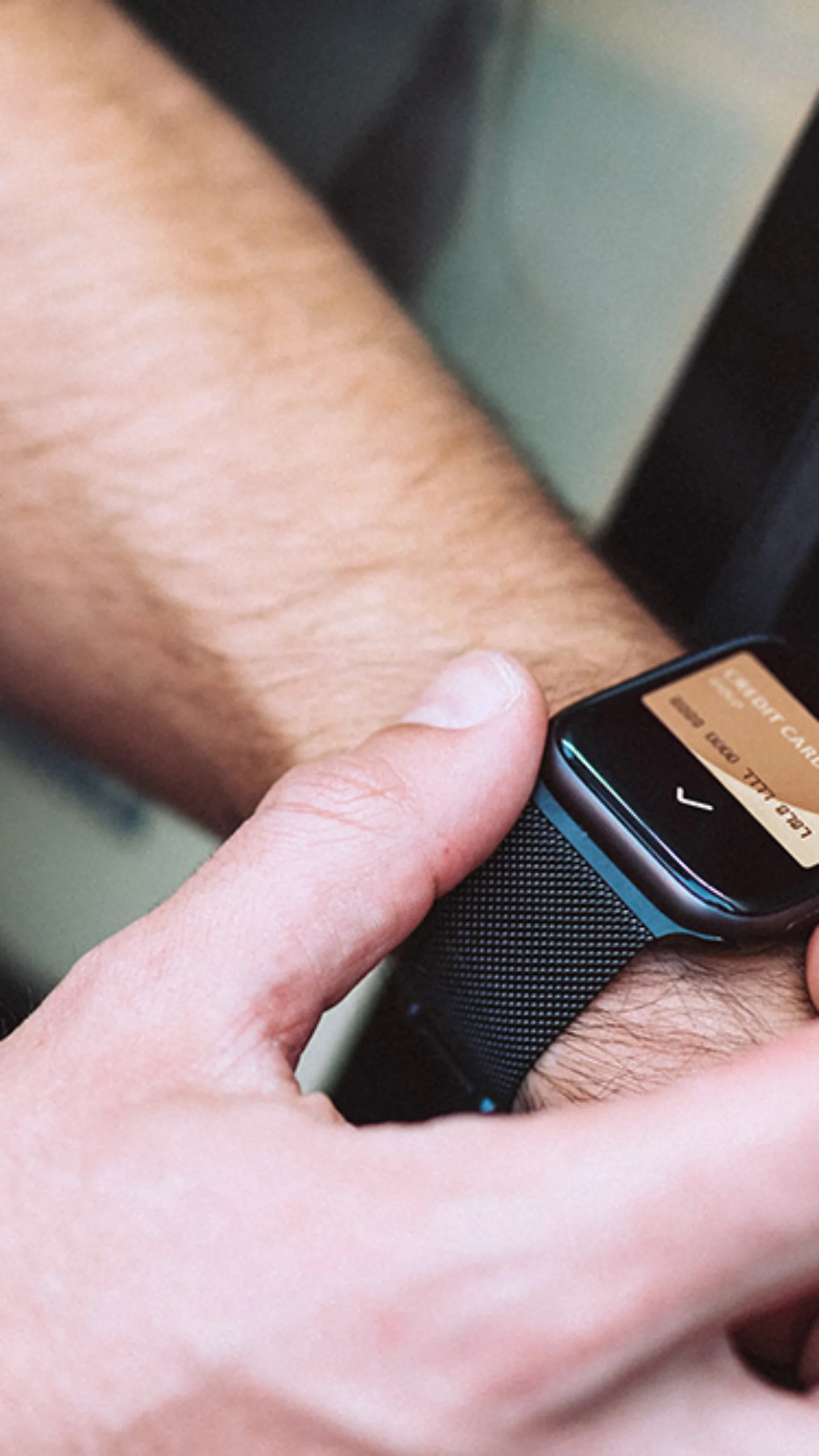 Close-up of a person using a smartwatch to interact with a modern vehicle&#039;s system, showcasing seamless technology integration in automotive design.