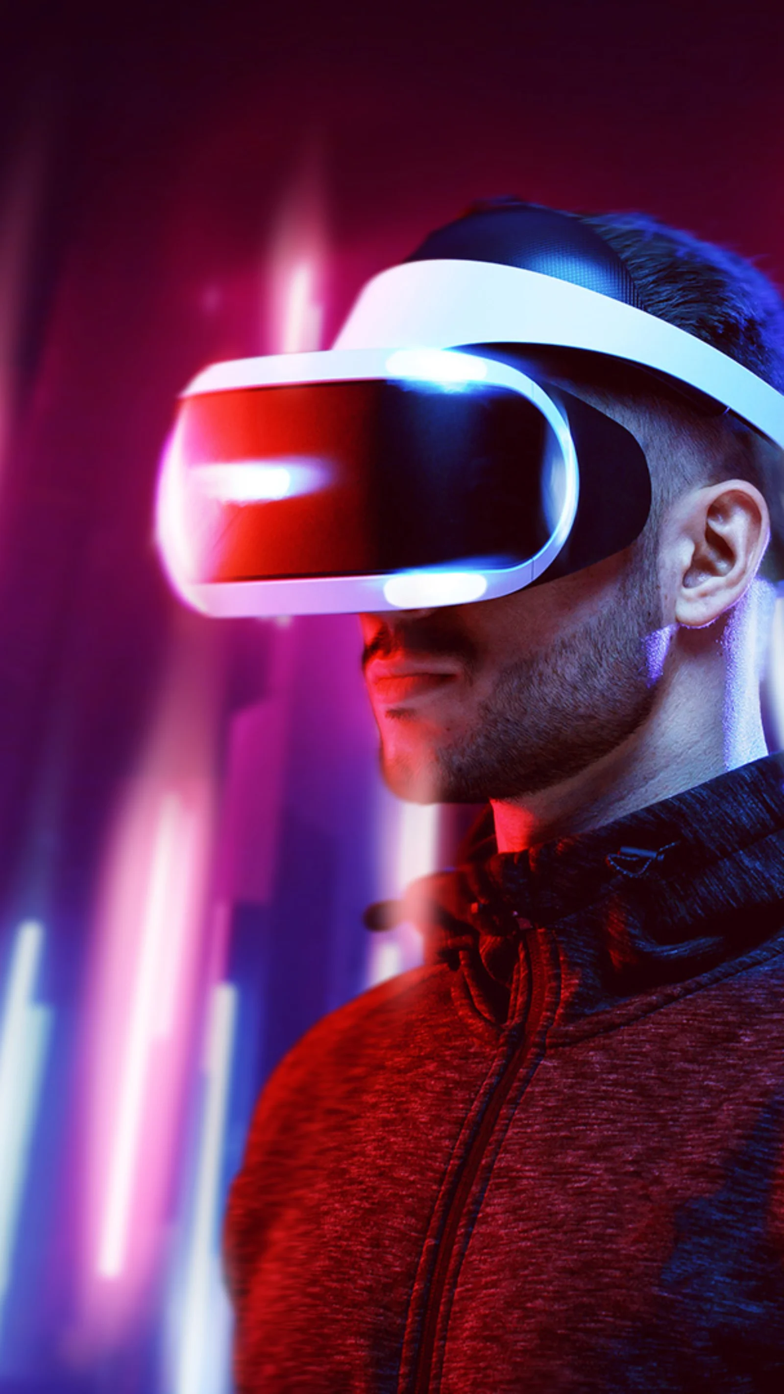 A person wearing a VR headset, illuminated by vibrant, colourful lights, representing the cutting-edge of immersive technology.