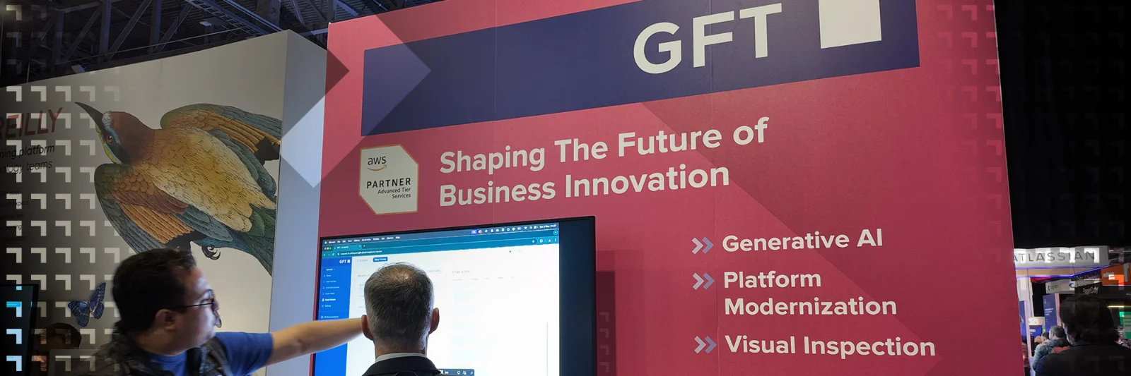 GFT exhibition booth with a banner reading &quot;Shaping the Future of Business Innovation,&quot; highlighting services such as Generative AI, Platform Modernization, and Visual Inspection. Two individuals are interacting with a screen showcasing GFT technology solutions.