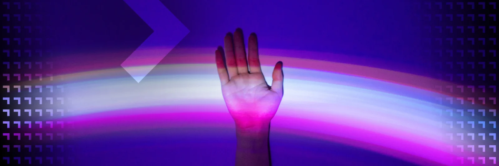 Hand raised against a background of colorful light streaks, symbolizing the connection between human interaction and digital technology.