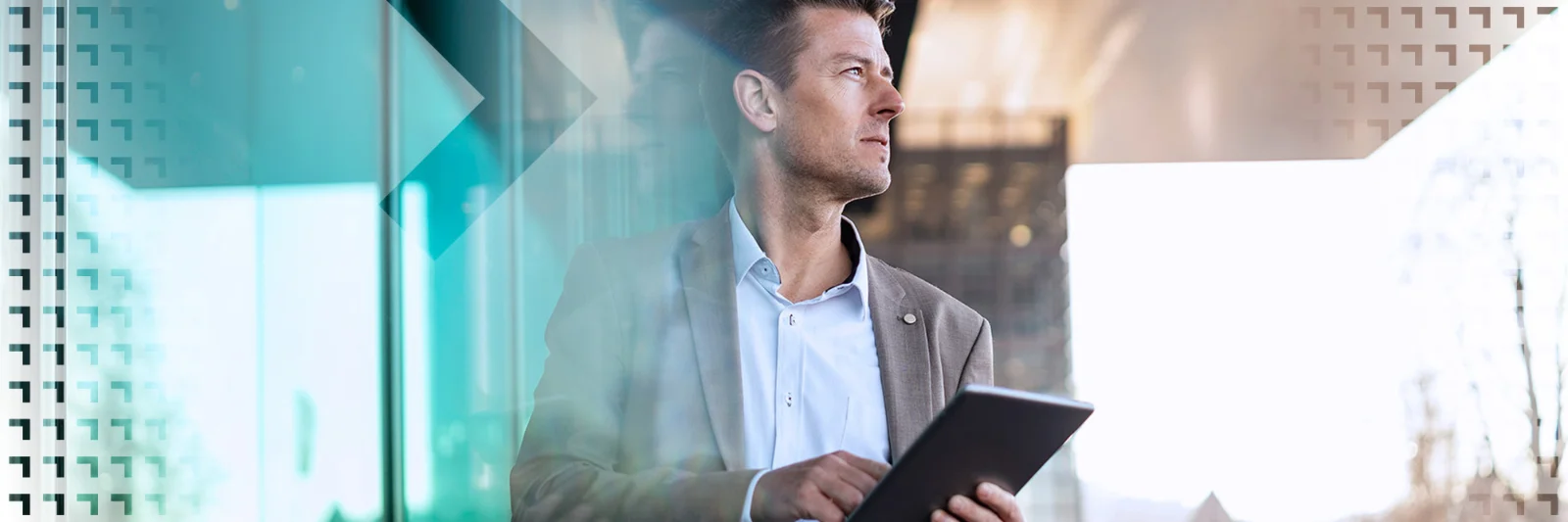 A business professional holding a tablet and looking thoughtfully out of a window, symbolizing strategic planning and modern technology in a corporate setting.