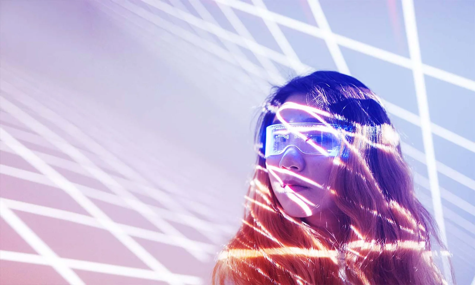 A woman wearing futuristic glasses illuminated by intersecting lines of light.