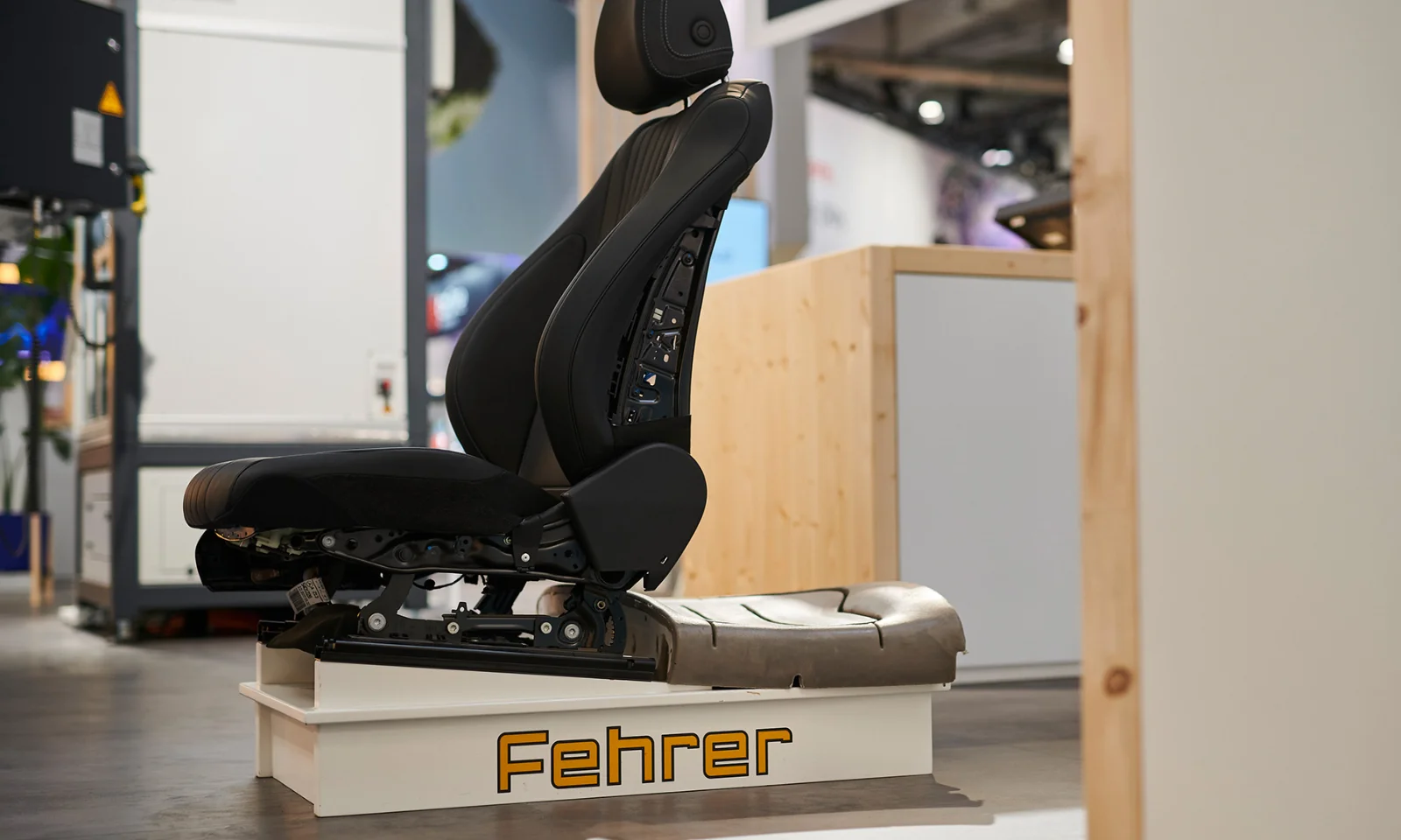 A prototype of an automotive seat by Fehrer, displayed in a modern manufacturing setting, illustrating innovation in production.