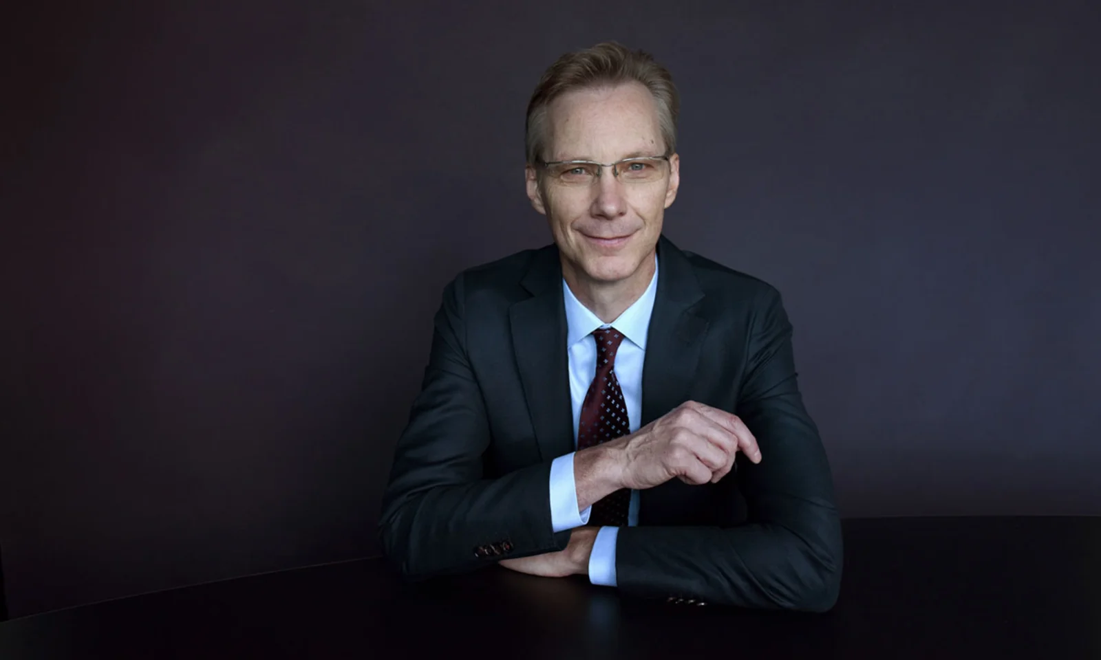 Jochen Rütz, Member of the Administrative Board, posing in a professional setting against a dark background