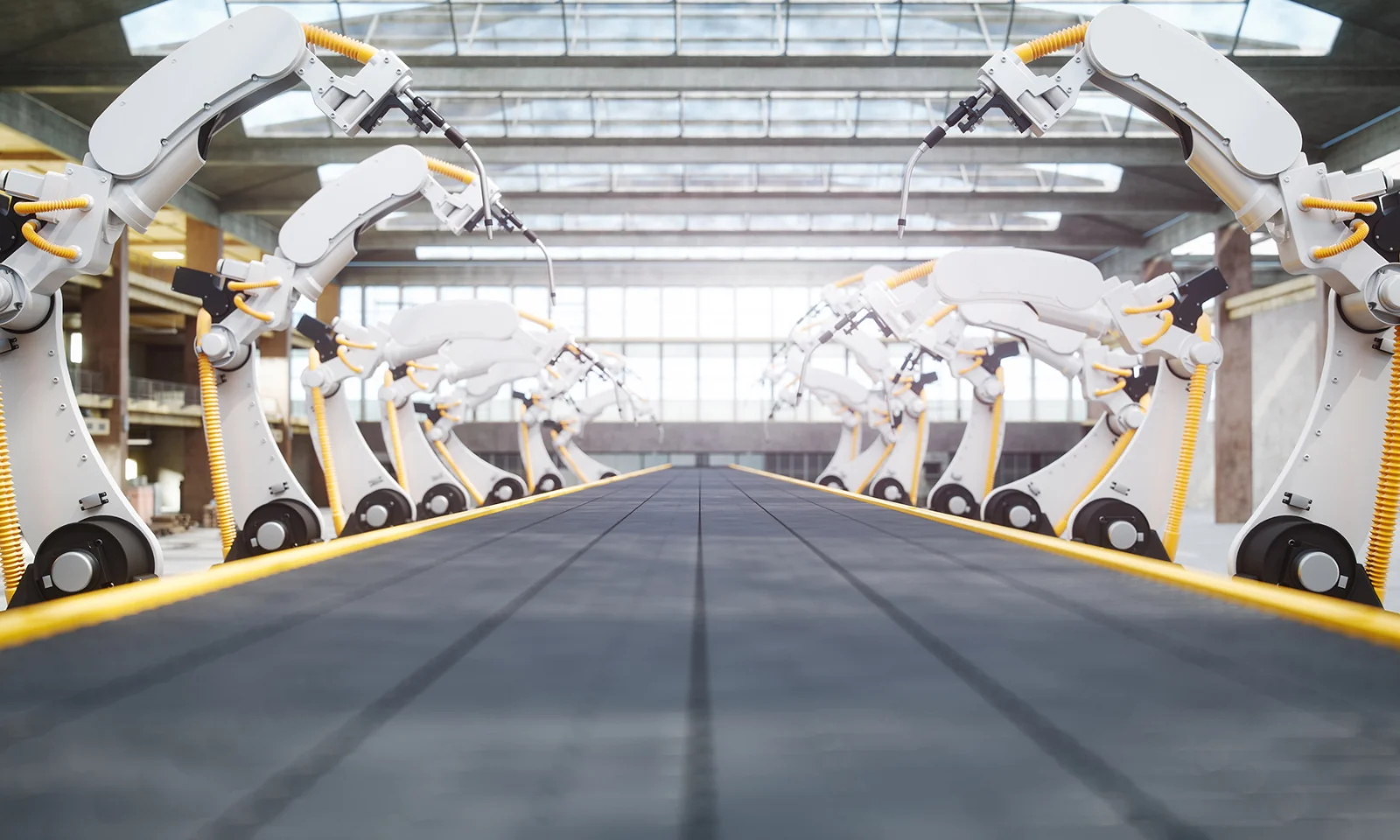 Row of robotic arms operating on an automated assembly line in a modern industrial facility.