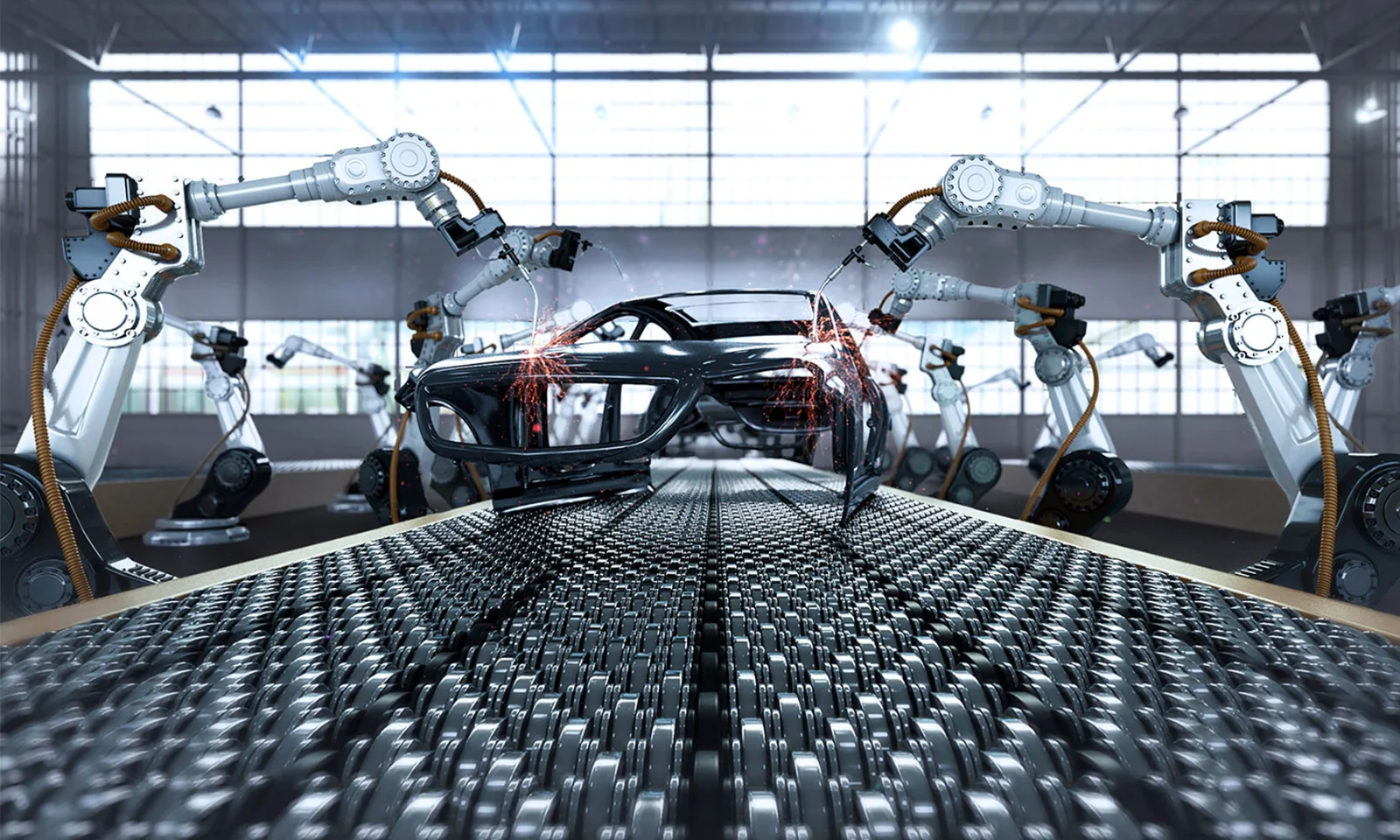 Robotic arms welding a car chassis on an automated production line in a modern factory setting.