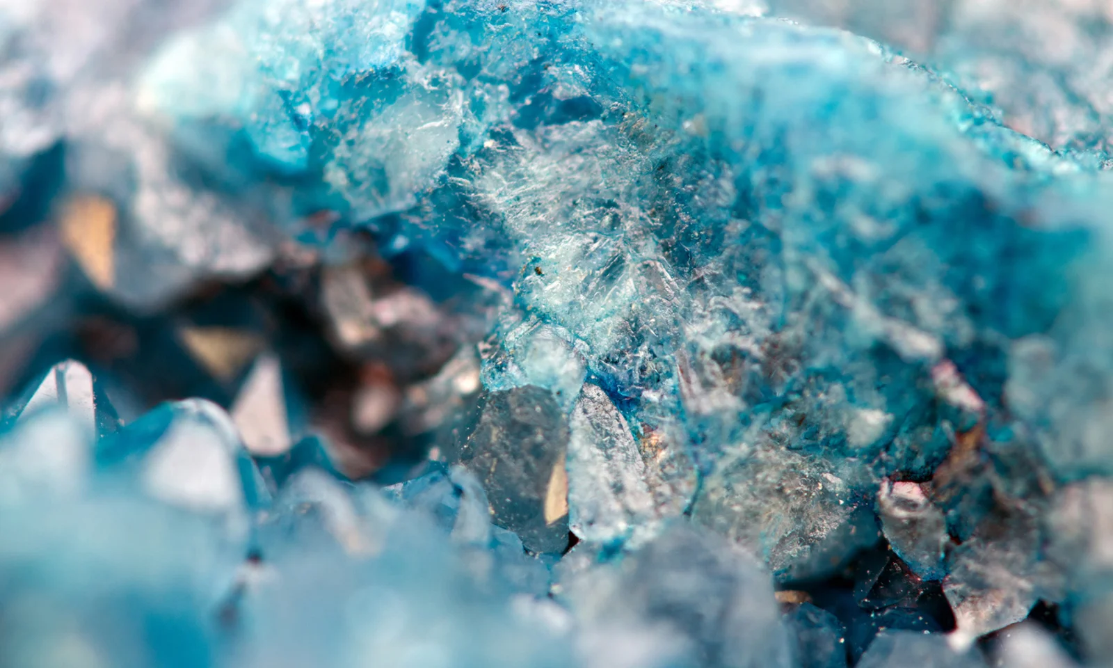 Close-up of intricate blue crystal formations, symbolising the precision and security of database management and policy as code in the Azure Cloud.