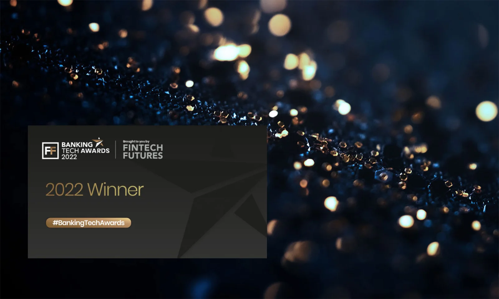 Close-up of a dark, glittering surface with a 2022 Banking Tech Awards winner badge from Fintech Futures.