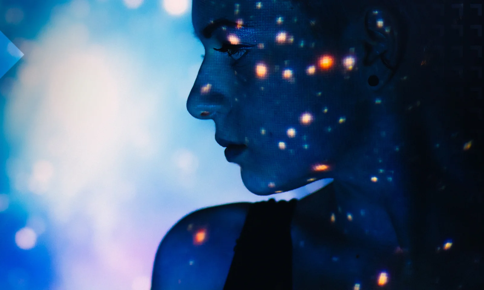 Silhouette of a woman with digital lights projected on her face, set against a vibrant, futuristic background.