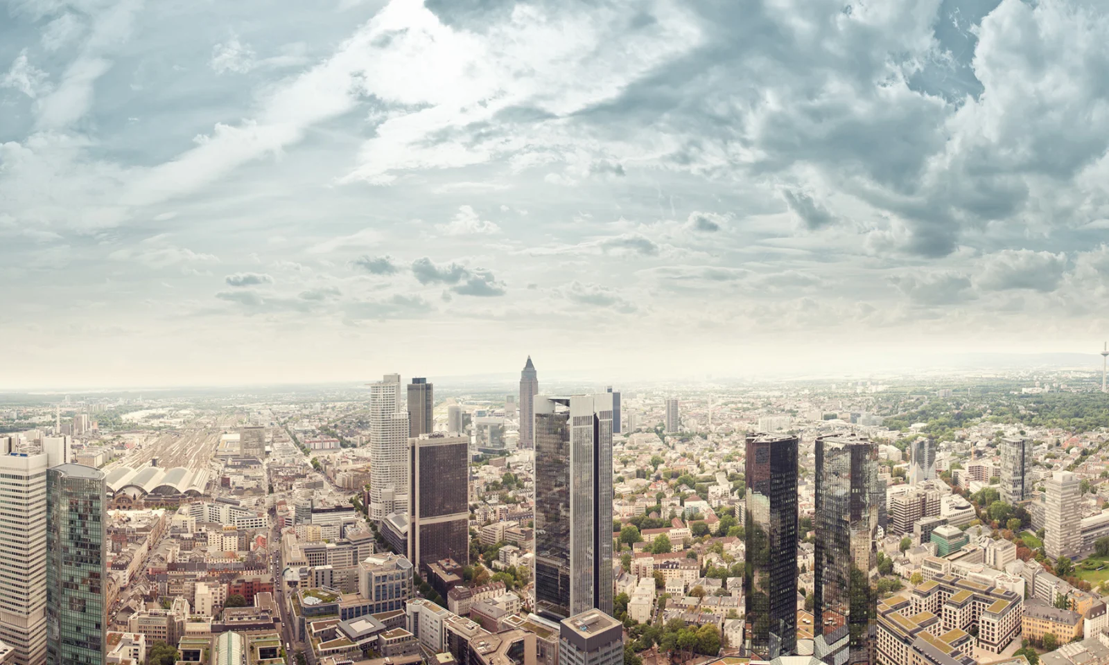 Une vue panoramique d&#039;un horizon urbain moderne avec des bâtiments imposants, représentant le parcours de replateforme de DekaBank avec GFT.