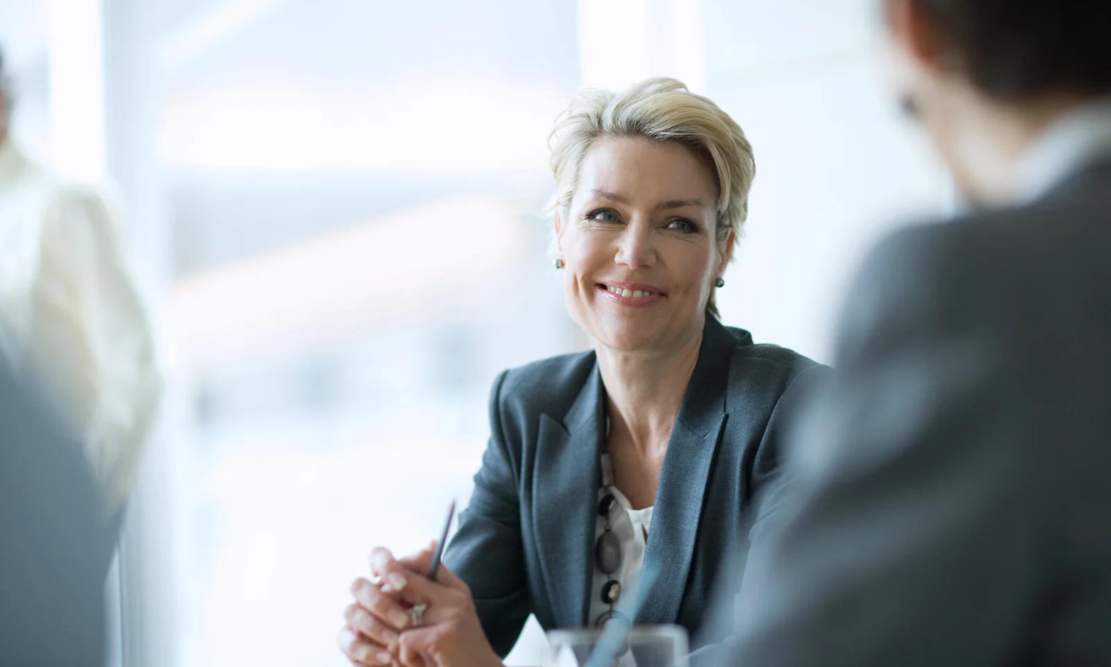 A confident businesswoman in a meeting, symbolizing investor relations and corporate communication.