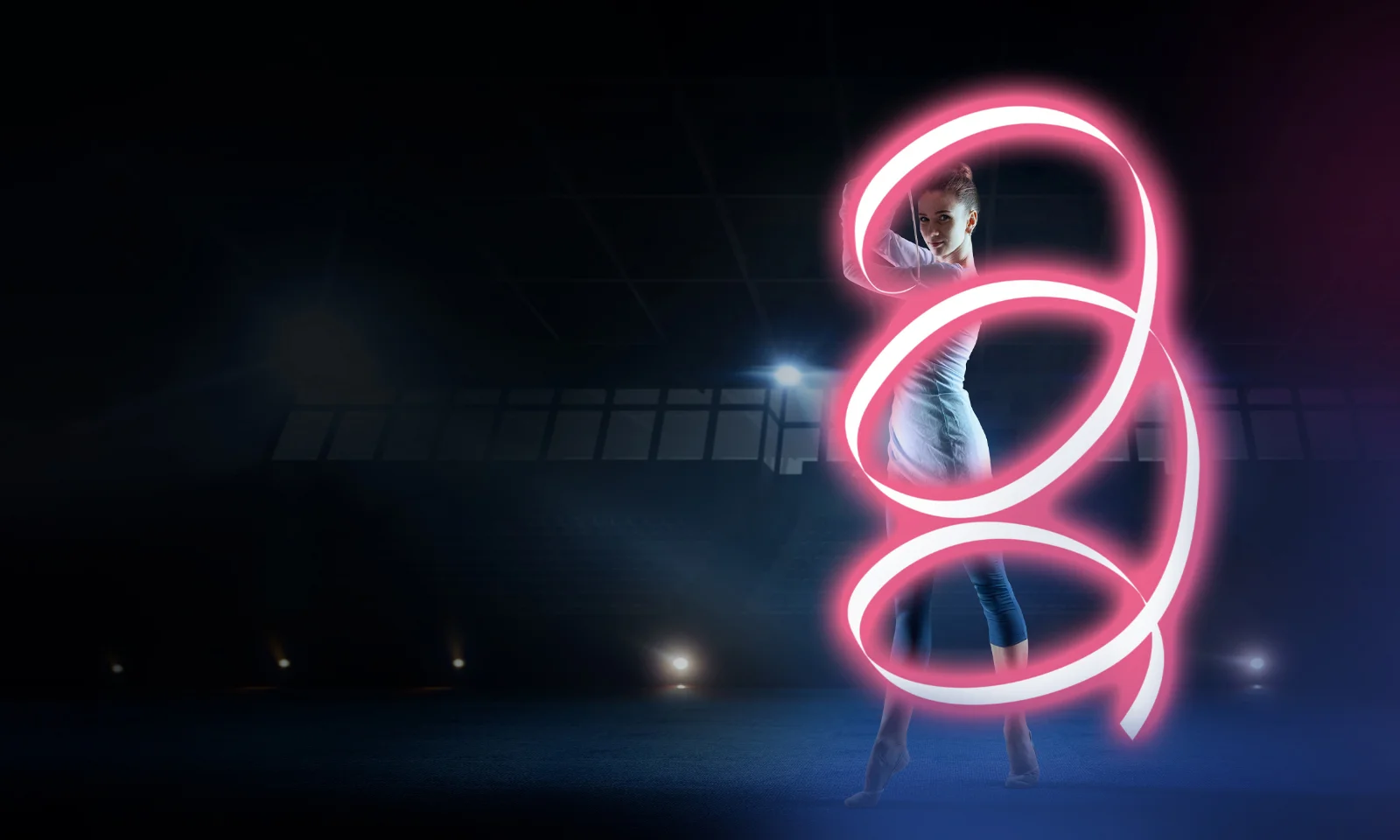 A woman performing a dynamic dance move with illuminated neon loops symbolising digital transformation in a dark, futuristic setting.