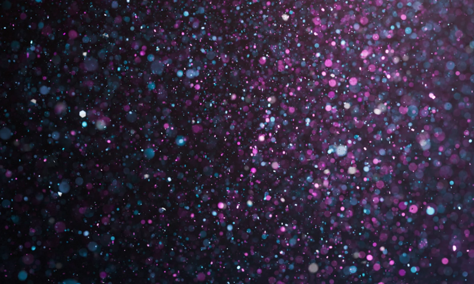 Abstract image with a left-aligned focus, featuring a glittering background of purple, blue, and white sparkles. The design symbolises GFT&#039;s numerous awards and achievements.