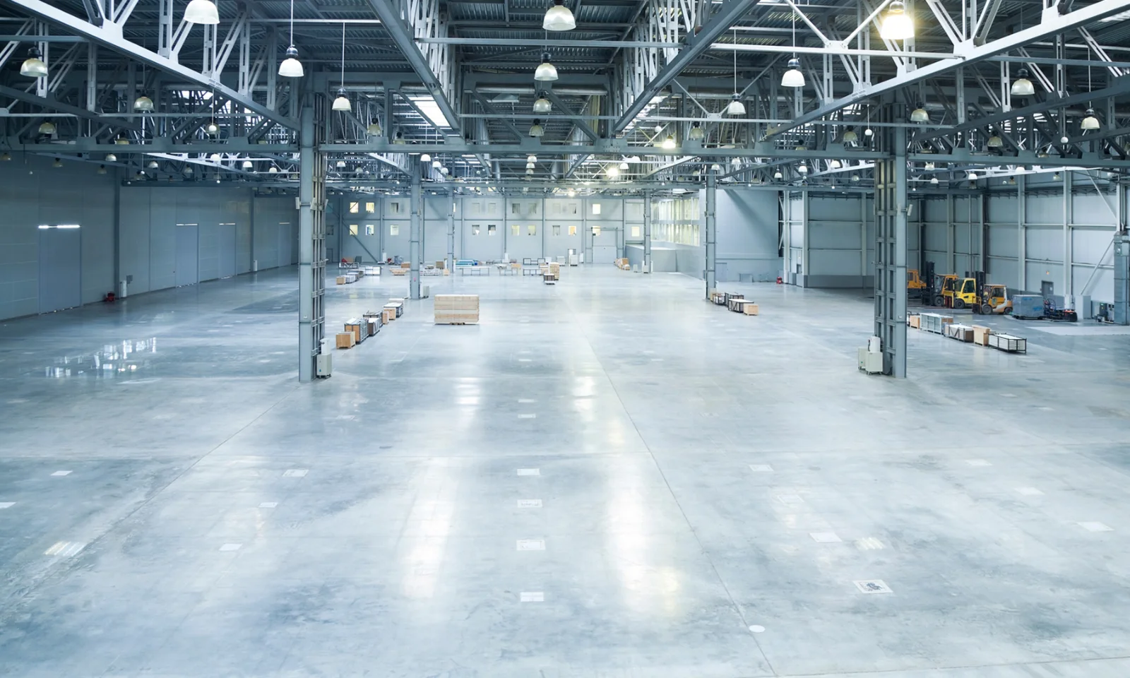 Spacious and modern warehouse interior with minimal storage and industrial lighting.