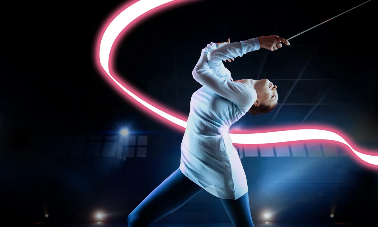 A female fencer in a white fencing uniform strikes a dramatic pose, bending backward while holding her sword. A vibrant pink neon light trail arcs behind her, enhancing the dynamic and energetic atmosphere of the scene.